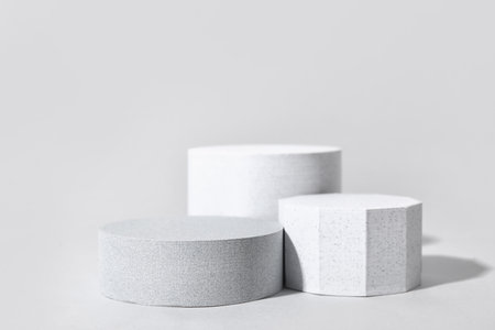 Decorative plaster podiums on gray backgroundの写真素材