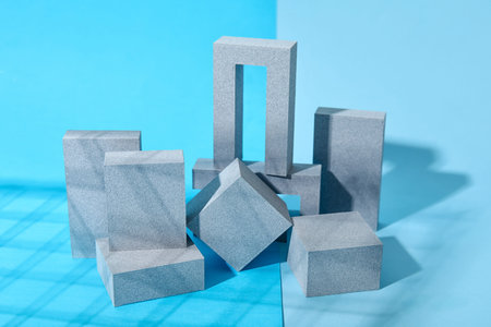 Different decorative plaster podiums on blue background