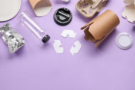 Recycling sign with garbage on lilac background