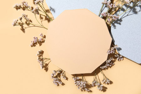 Decorative plaster podiums with gypsophila flowers on beige backgroundの写真素材