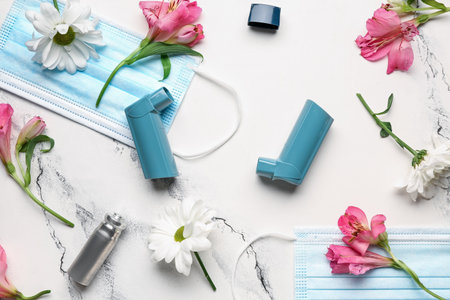 Asthma inhalers with medical masks and flowers on grunge backgroundの写真素材