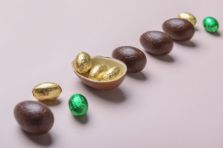 Sweet chocolate Easter eggs and candies on light backgroundの写真素材