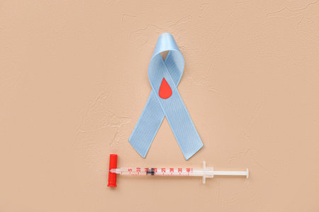 Awareness ribbon with syringe on beige background. Diabetes conceptの写真素材