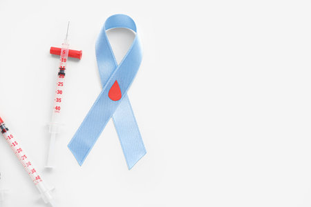 Awareness ribbon with syringes on white background. Diabetes conceptの写真素材