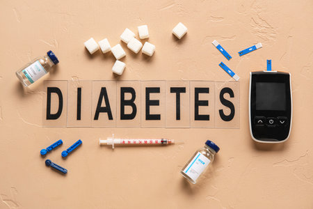 Word DIABETES with glucometer, insulin and sugar on beige backgroundの写真素材
