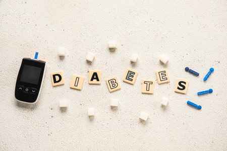 Word DIABETES with glucometer, strips and sugar on white backgroundの写真素材