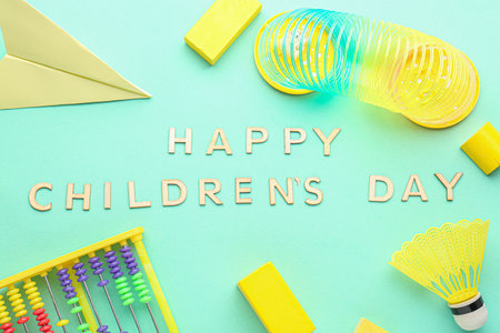 Text HAPPY CHILDREN'S DAY with toys on green backgroundの写真素材