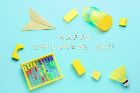 Text HAPPY CHILDREN'S DAY with toys on blue backgroundの写真素材