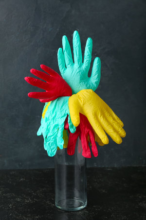 Vase with medical gloves on dark backgroundの写真素材