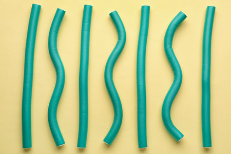 Hair curlers on yellow backgroundの写真素材