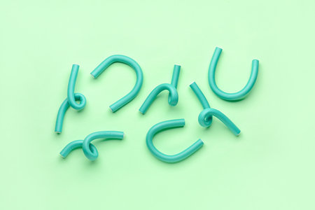 Hair curlers on green backgroundの写真素材