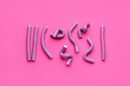 Hair curlers on pink backgroundの写真素材