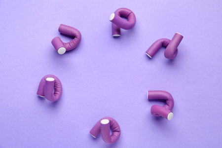 Frame made of hair curlers on lilac backgroundの写真素材