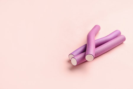 Hair curlers on pink backgroundの写真素材