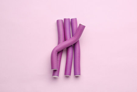 Hair curlers on pink backgroundの写真素材