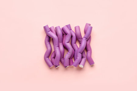 Hair curlers on pink backgroundの写真素材