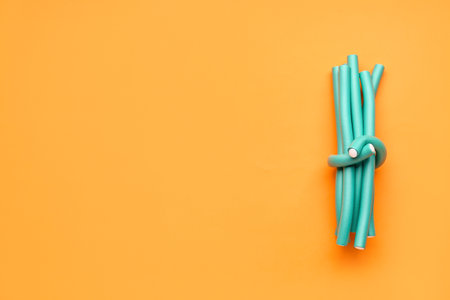 Hair curlers on orange backgroundの写真素材