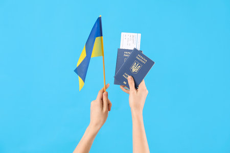 Woman with passports, ticket and flag of Ukraine on blue backgroundの写真素材