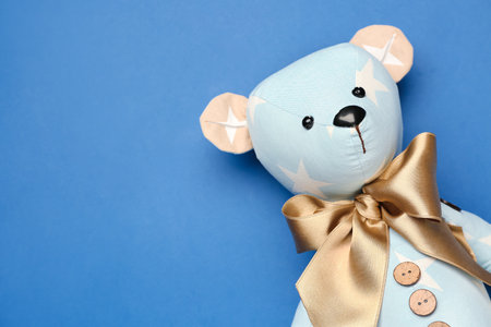 Toy bear on blue background, closeupの写真素材
