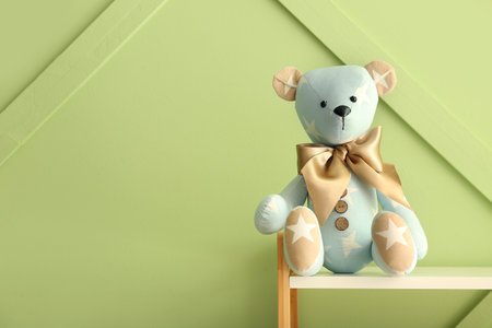 Toy bear on shelf near green wallの写真素材