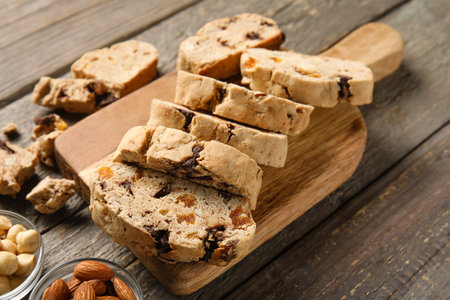 Board with delicious biscotti cookies on wooden backgroundの写真素材