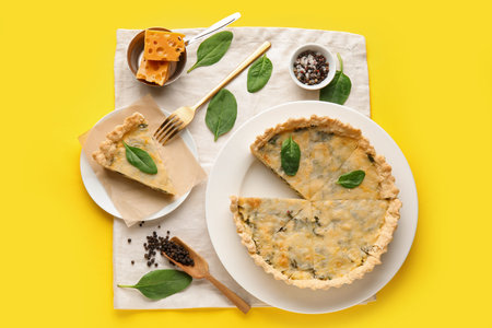 Plates with pieces of delicious quiche on yellow background