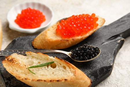 Tasty bruschettas with red and black caviar on grunge backgroundの写真素材