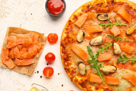 Tasty seafood pizza and ingredients on light background, closeupの写真素材