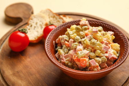 Bowl of tasty Olivier salad on yellow background, closeupの写真素材