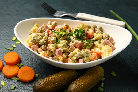 Bowl of tasty Olivier salad on dark backgroundの写真素材