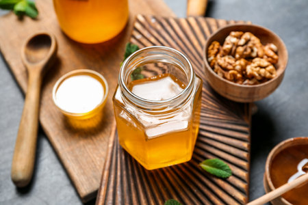 Jar of sweet honey on dark backgroundの写真素材