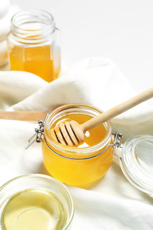 Jar with sweet honey on white backgroundの写真素材
