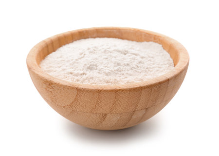 Wooden bowl with wheat flour isolated on white backgroundの写真素材