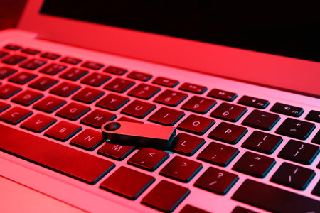 Metallic USB flash drive on modern laptop, closeupの写真素材