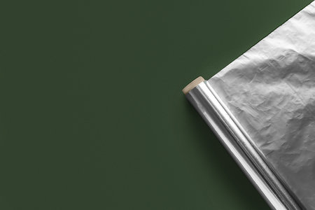 Aluminum foil roll on green backgroundの写真素材