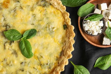 Delicious quiche, feta and cottage cheese on black napkin, closeupの写真素材