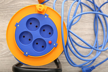 Extension electric cable reel on light wooden background, closeupの写真素材