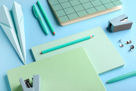 Composition with stationery supplies and paper plane on blue backgroundの写真素材