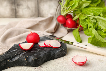 Wooden board fresh cut radish on tableの写真素材