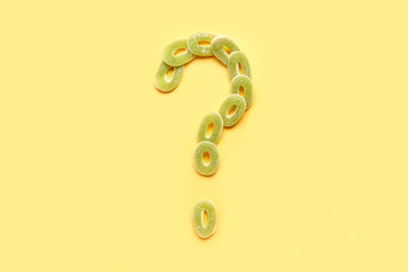 Question mark made of jelly candies on yellow backgroundの写真素材