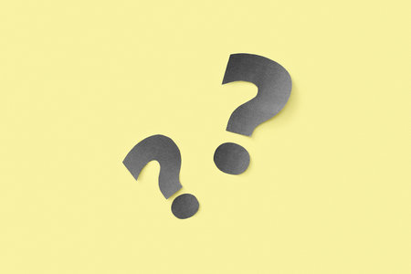 paper question mark on yellow background