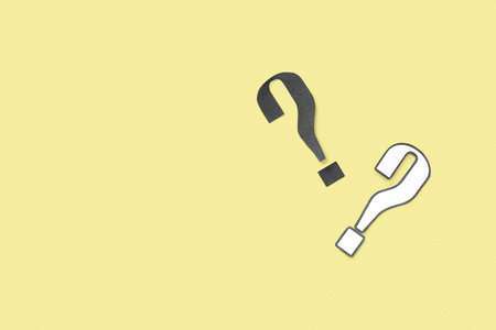 paper question mark on yellow background