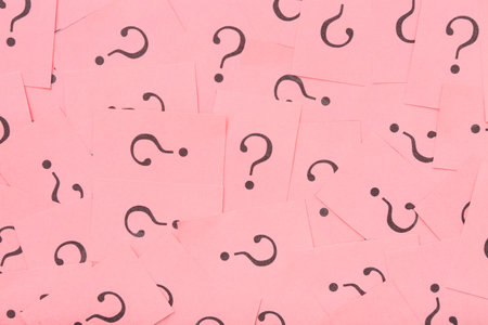 Pink papers with question marks as backgroundの写真素材