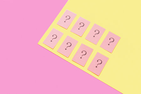 Papers with question marks on color backgroundの写真素材