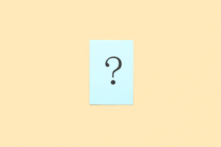 Paper with question mark on yellow background