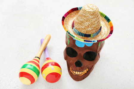 Mexican maracas with painted skull and sombrero hat on white backgroundの写真素材