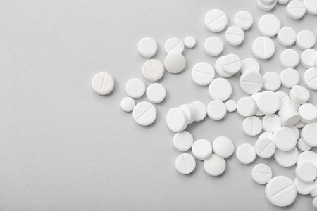 White pills on gray backgroundの写真素材