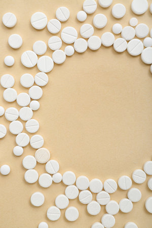 Frame made of white pills on beige backgroundの写真素材