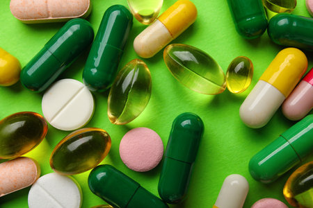 Different pills on green background, closeupの写真素材