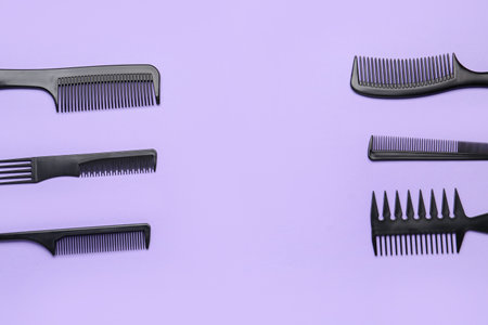 Frame made of hairdresser's brushes on lilac backgroundの写真素材